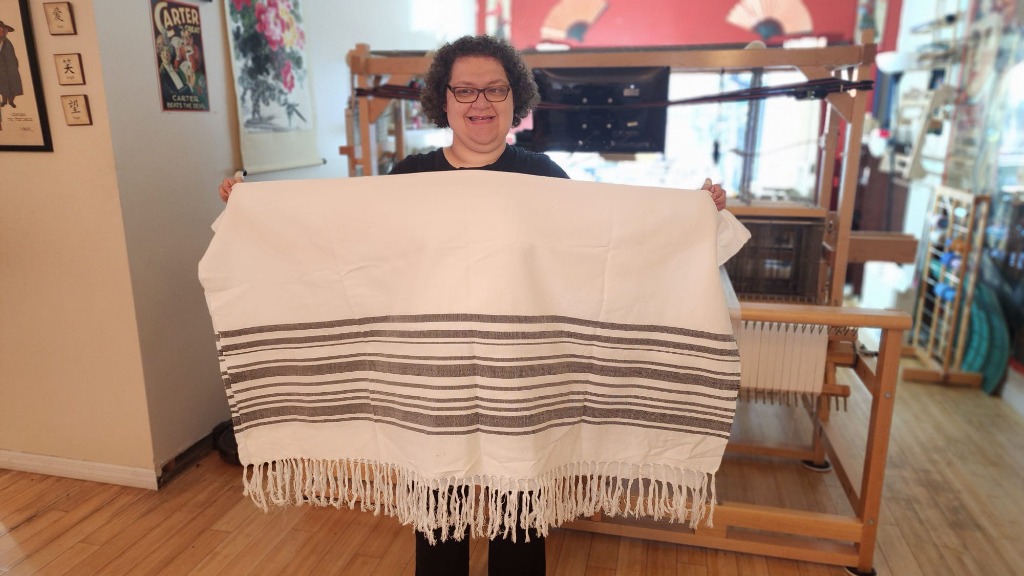 Leslie displaying her woven work